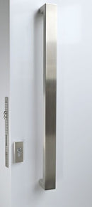 Stainless steel door handle and lock on a white door