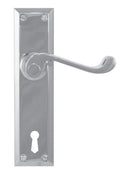 Metal door handle with keyhole on a white background