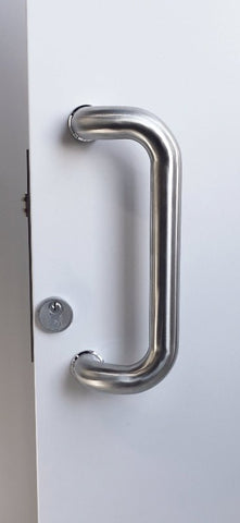 Metal door handle on a white door