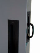 Close-up of a door handle and lock mechanism on a gray door.