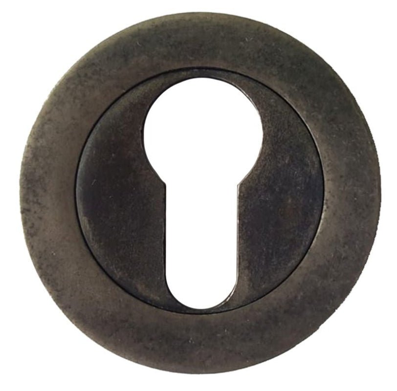 Round metal keyhole cover with a keyhole in the center on a white background