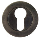Round metal keyhole cover with a keyhole in the center on a white background