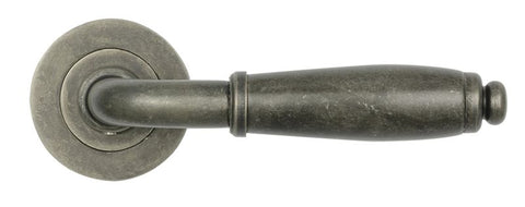 Decorative metal door handle on a white background