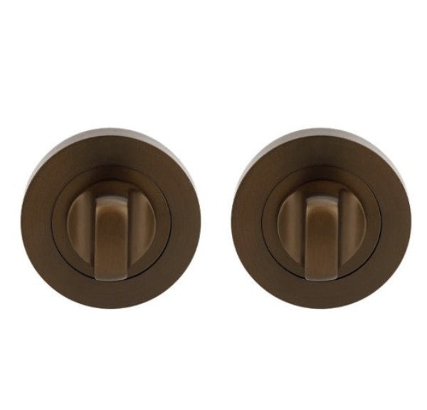 Two bronze door handles on a white background