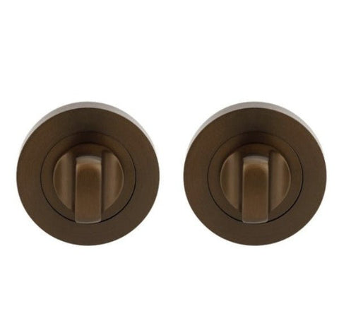 Two bronze door handles on a white background