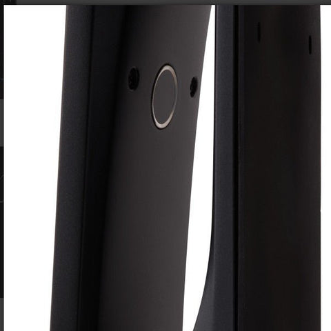 Close-up of a black electronic device with a circular component on a white background