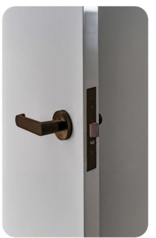 White door with a bronze handle and lock on a white background