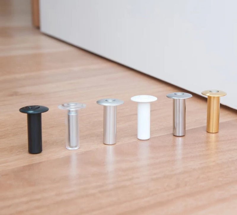 Clear cylindrical object and silver cylindrical object on a wooden surface