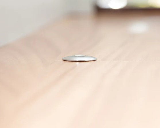Close-up of a metallic object on a beige surface