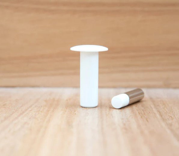 White cylindrical object on a wooden surface