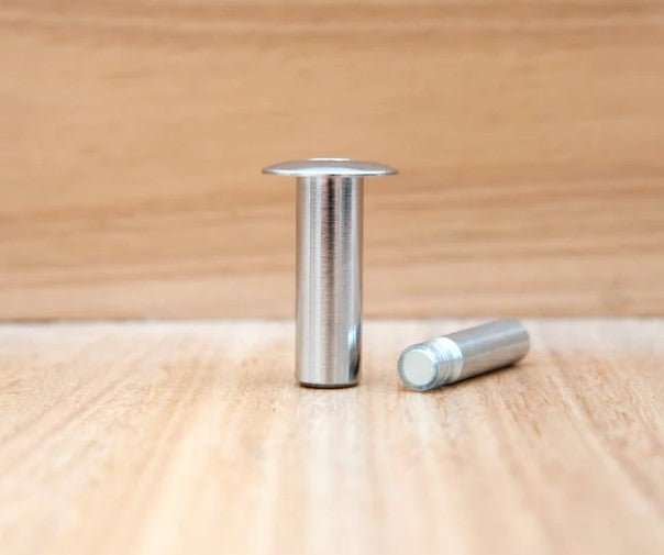 Metallic cylindrical objects on a wooden surface