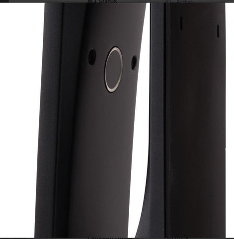 Close-up of a black electronic device with a circular component on a white background