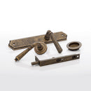 Set of vintage-style door handles and lock mechanism on a white background