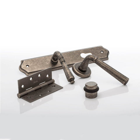 Set of metal door handles and hinges on a white background