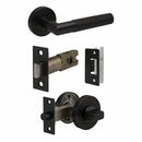 A set of bronze-finished door hardware components on a plain white background, including a lever handle, latch mechanism, lock plate, and deadbolt assembly.