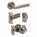 A set of bronze-finished door hardware components on a plain white background, including a lever handle, latch mechanism, lock plate, and deadbolt assembly.