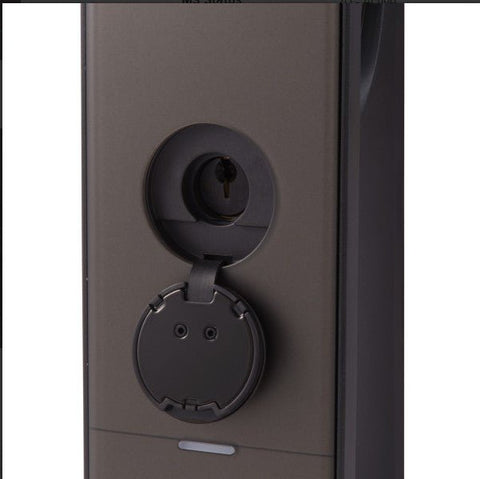 Close-up of a black door handle on a dark surface