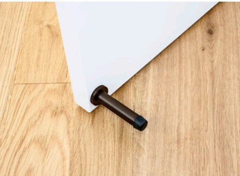 Ember Bronze Door stop mounted on the white door