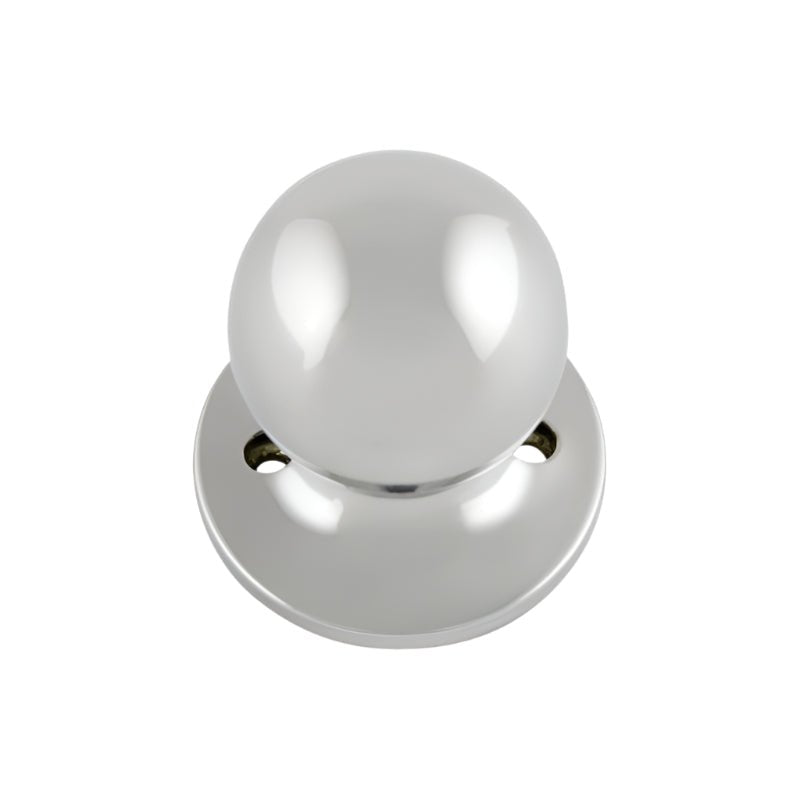 Polished chrome door knob on a white background