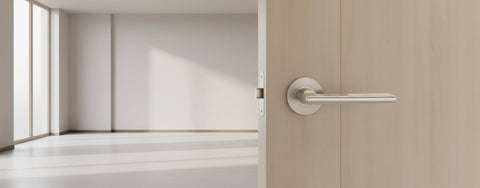 Stainless steel door handle on a white background